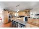 Bright kitchen features a large island, stainless steel refrigerator, and light wood cabinetry at 2047 S Franklin St, Denver, CO 80210