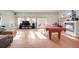 Spacious room with a red billiard table, decorative fireplace and large windows at 2047 S Franklin St, Denver, CO 80210