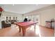 Bright living area with a pool table, ample seating, and large windows for natural light at 2047 S Franklin St, Denver, CO 80210
