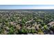 Expansive aerial view of a community nestled among trees, featuring well-spaced homes and nearby amenities at 2931 S Sidney Ct, Denver, CO 80231