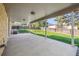 View of a covered patio with a concrete floor, and a large grassy yard with wood fence at 2931 S Sidney Ct, Denver, CO 80231