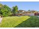 Expansive backyard showcasing a well-manicured lawn and a charming two-story brick home at 2931 S Sidney Ct, Denver, CO 80231