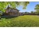 Beautiful, large backyard with green lawn leading to a brick home with a covered patio at 2931 S Sidney Ct, Denver, CO 80231