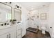 Modern bathroom with double sinks, elegant gold mirrors, and a walk-in shower at 2931 S Sidney Ct, Denver, CO 80231