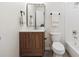 Stylish bathroom with a wood vanity, modern fixtures, and a tiled shower/tub combo, blending comfort and design at 2931 S Sidney Ct, Denver, CO 80231