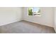 Bright and airy bedroom with neutral carpet and a large window providing natural light and serene outdoor views at 2931 S Sidney Ct, Denver, CO 80231