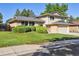 Charming two-story home with a manicured lawn and mature trees at 2931 S Sidney Ct, Denver, CO 80231