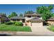 Charming two-story home with a manicured lawn, mature trees, and a two car garage at 2931 S Sidney Ct, Denver, CO 80231
