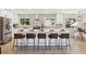 Modern kitchen island with white cabinets, quartz countertop, and seating at 2931 S Sidney Ct, Denver, CO 80231