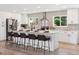 Modern kitchen island with white cabinets, quartz countertop, and bar stool seating at 2931 S Sidney Ct, Denver, CO 80231