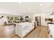 Modern open concept kitchen with large island, white cabinets, and stainless steel appliances at 2931 S Sidney Ct, Denver, CO 80231