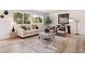 Cozy living room featuring a comfortable couch, stylish chairs, and large windows at 2931 S Sidney Ct, Denver, CO 80231