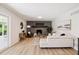 Well-lit living room offers a brick fireplace, modern decor, and access to the outdoor space at 2931 S Sidney Ct, Denver, CO 80231