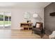 Bright living room with a sliding glass door to backyard and brick fireplace at 2931 S Sidney Ct, Denver, CO 80231
