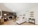 Bright living room featuring a brick fireplace, modern furnishings, and stylish decor at 2931 S Sidney Ct, Denver, CO 80231