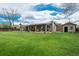 A large backyard with a covered patio, offering a perfect space for outdoor entertaining and relaxation at 8151 S Marshall Ct, Littleton, CO 80128