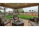 Backyard patio with cozy seating around a stylish stone fire pit on the wood deck at 8151 S Marshall Ct, Littleton, CO 80128