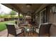 Cozy covered patio with a fire pit, plush seating and a wood plank ceiling at 8151 S Marshall Ct, Littleton, CO 80128