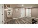 Spacious finished basement with workout equipment, neutral walls, and wood-look flooring at 8151 S Marshall Ct, Littleton, CO 80128