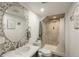 Bathroom featuring river rock tile wall behind round mirror and a walk-in shower at 8151 S Marshall Ct, Littleton, CO 80128