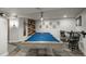 Basement game room featuring a pool table, pub seating, and stylish decor at 8151 S Marshall Ct, Littleton, CO 80128
