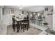 Eat-in kitchen features updated lighting, cabinetry and marble tile flooring at 8151 S Marshall Ct, Littleton, CO 80128
