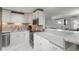 Bright kitchen featuring white cabinetry, stainless steel appliances, mosaic tile backsplash and granite countertops at 8151 S Marshall Ct, Littleton, CO 80128