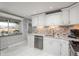 Bright kitchen featuring stainless steel appliances, mosaic tile backsplash and modern countertops at 8151 S Marshall Ct, Littleton, CO 80128