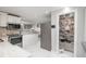 Bright kitchen with stainless appliances, granite countertops and a walk-in pantry for ample storage at 8151 S Marshall Ct, Littleton, CO 80128