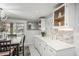 Eat-in kitchen features updated lighting, cabinetry and marble tile flooring at 8151 S Marshall Ct, Littleton, CO 80128
