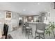 Bright, open-concept kitchen with breakfast bar and marble tile flooring at 8151 S Marshall Ct, Littleton, CO 80128