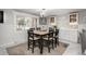 Eat-in kitchen features updated lighting, cabinetry and marble tile flooring at 8151 S Marshall Ct, Littleton, CO 80128