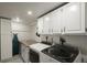Spacious laundry room with modern washer and dryer, cabinetry, and countertop space at 8151 S Marshall Ct, Littleton, CO 80128