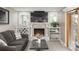Spacious living room with fireplace, built-in shelving, and a wine rack at 8151 S Marshall Ct, Littleton, CO 80128