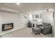 Finished basement living area with a fireplace and comfortable armchair seating at 8151 S Marshall Ct, Littleton, CO 80128