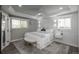 Bright main bedroom suite with tray ceiling, modern lighting, and ensuite bath at 8151 S Marshall Ct, Littleton, CO 80128