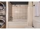 Bathroom with a shower-tub combination and stacked washer and dryer at 1000 E 18Th Ave # 107, Denver, CO 80218