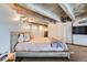 Bedroom with modern gray and pink bedding, industrial ceiling, and carpet at 1000 E 18Th Ave # 107, Denver, CO 80218