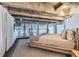 Modern bedroom with exposed concrete ceiling and large windows providing natural light at 1000 E 18Th Ave # 107, Denver, CO 80218