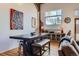 Open dining area with a large table, a bench, and a view of the living room and a large window at 1000 E 18Th Ave # 107, Denver, CO 80218