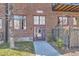 Brick entrance with burgundy trim, side-walk and security gate at 1000 E 18Th Ave # 107, Denver, CO 80218