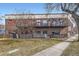 Brick building with balconies, showcasing architectural details and outdoor living spaces at 1000 E 18Th Ave # 107, Denver, CO 80218