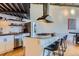 Open kitchen with eat-in island, stainless appliances, and modern industrial design at 1000 E 18Th Ave # 107, Denver, CO 80218