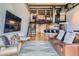 Bright living room showing stairs to second level, modern kitchen, hardwood floors and decor at 1000 E 18Th Ave # 107, Denver, CO 80218
