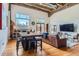 Bright living room with hardwood floors, exposed brick accents, high ceilings and modern furnishings at 1000 E 18Th Ave # 107, Denver, CO 80218