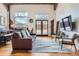 Spacious living room with hardwood floors, modern decor, and ample natural light at 1000 E 18Th Ave # 107, Denver, CO 80218