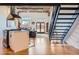 Bright living space with exposed brick and hardwood floors adjacent to modern kitchen at 1000 E 18Th Ave # 107, Denver, CO 80218
