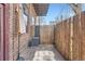 Private brick patio with bamboo fencing, offering a secluded outdoor space at 1000 E 18Th Ave # 107, Denver, CO 80218