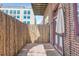 Charming patio area enclosed by bamboo, adjacent to a brick building at 1000 E 18Th Ave # 107, Denver, CO 80218