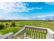 Relaxing backyard view from a porch, featuring a lush green lawn and distant open fields at 42425 Forest Oaks Dr, Elizabeth, CO 80107